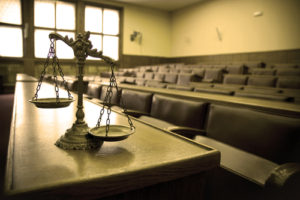 scales of justice in courtroom